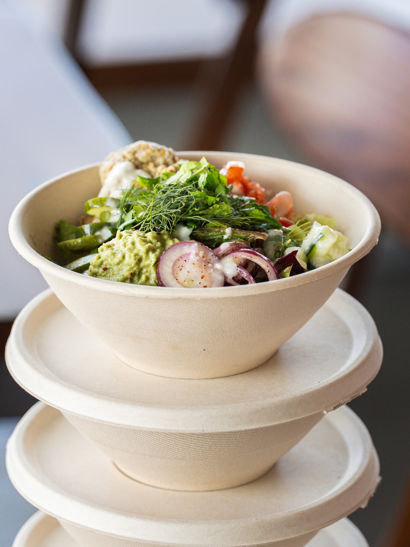 Build your own bowl with falafel, avocado, herbs and pickled onions