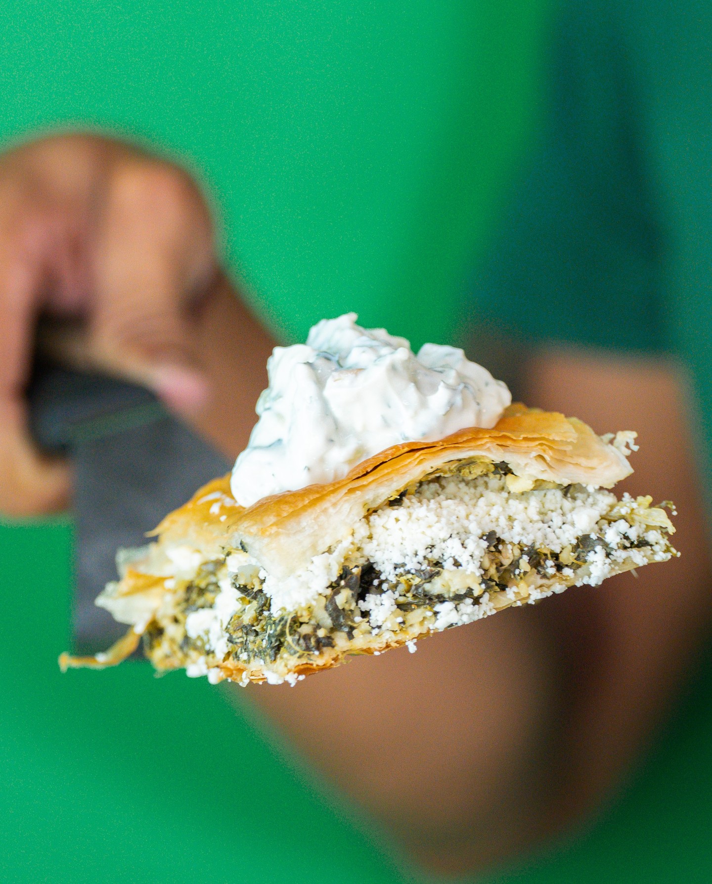 Spanakopita with feta and spinach, topped with tzatziki